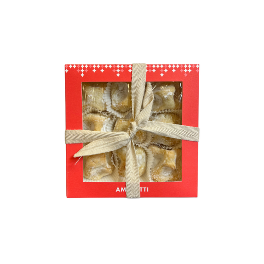 Red box with a gold bow containing cookies on a white background