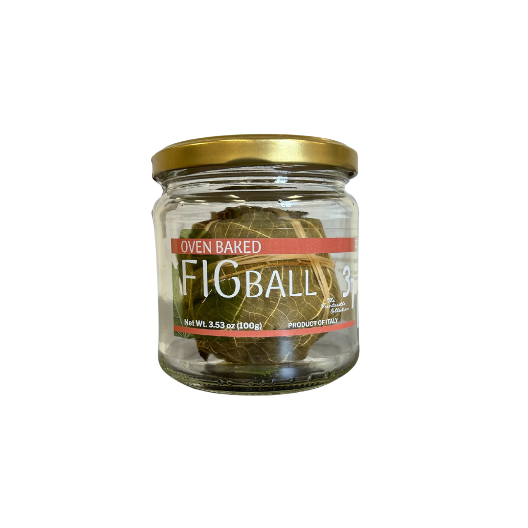 Jar of oven baked fig balls with a gold lid on a white background
